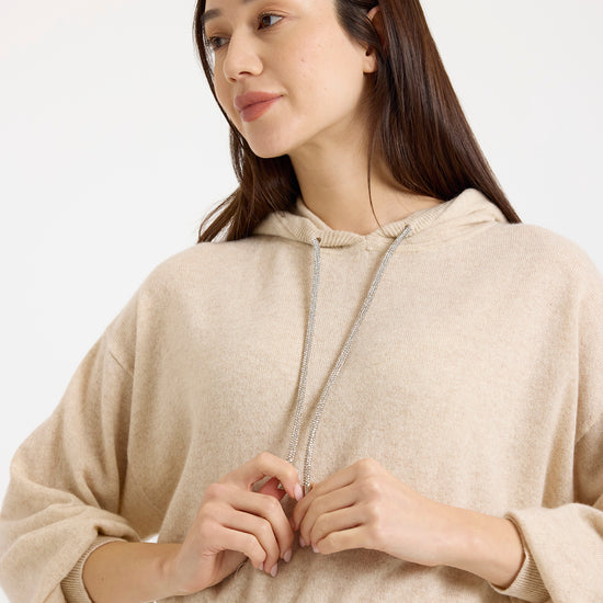 beige cashmere hoodie with rhinestone drawstring model shot