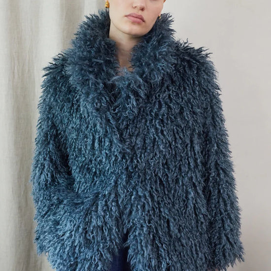Blue faux fur short jacket worn with blue jeans