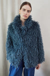 Blue faux fur short jacket worn with blue jeans