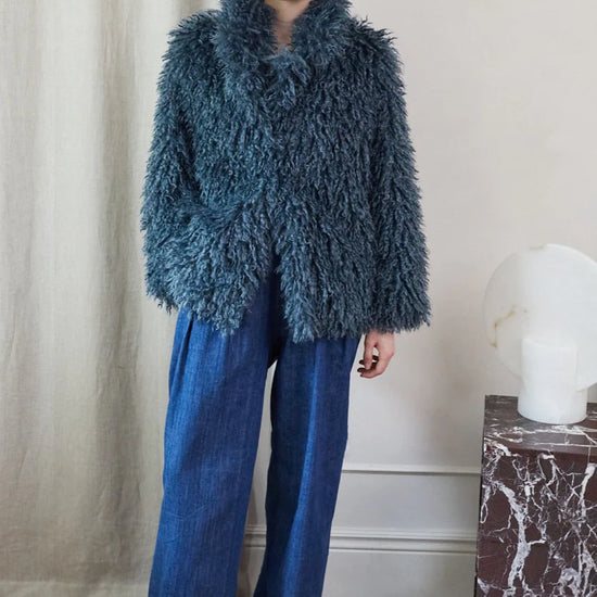 Blue faux fur short jacket worn with blue jeans