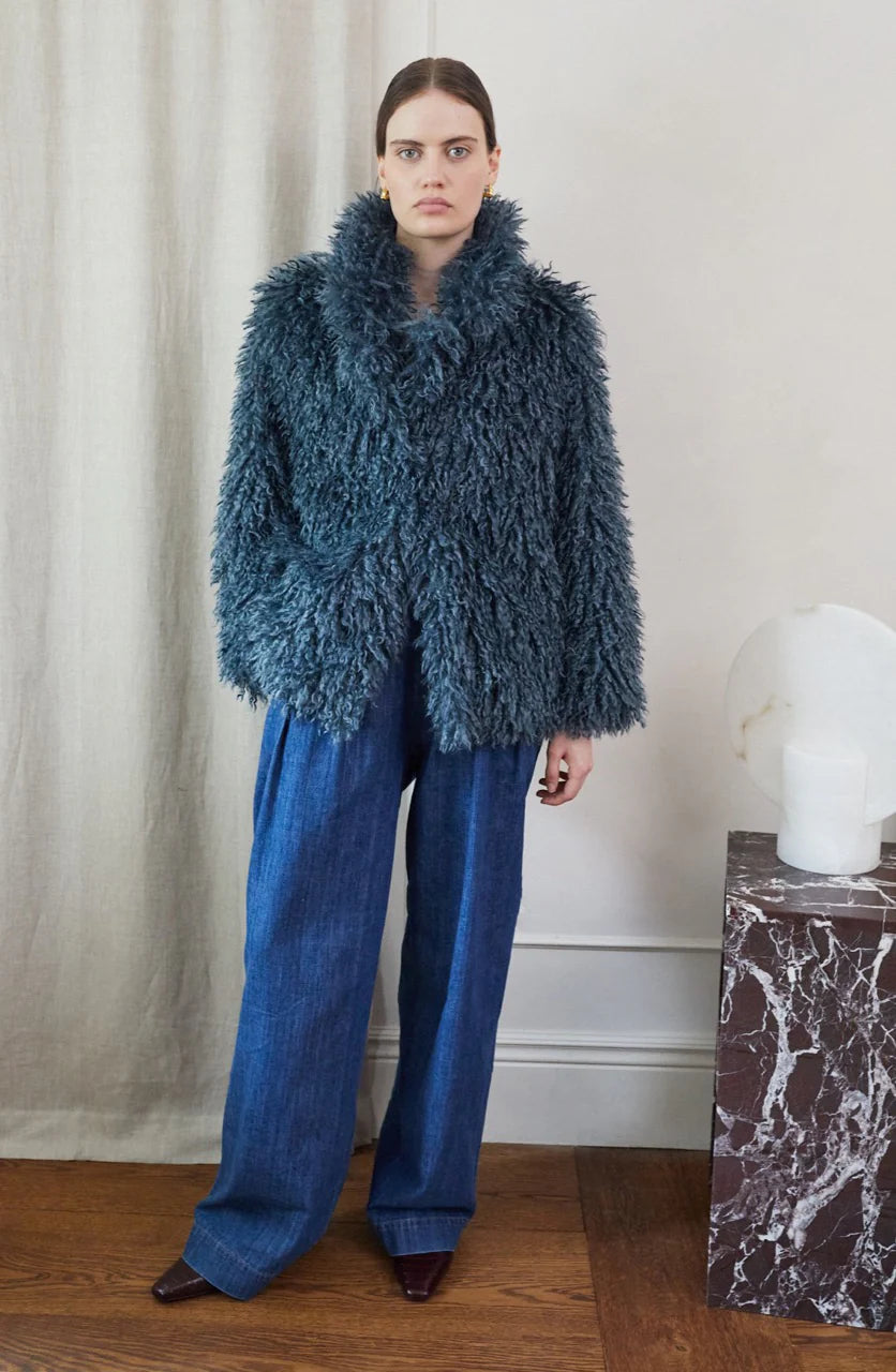 Blue faux fur short jacket worn with blue jeans