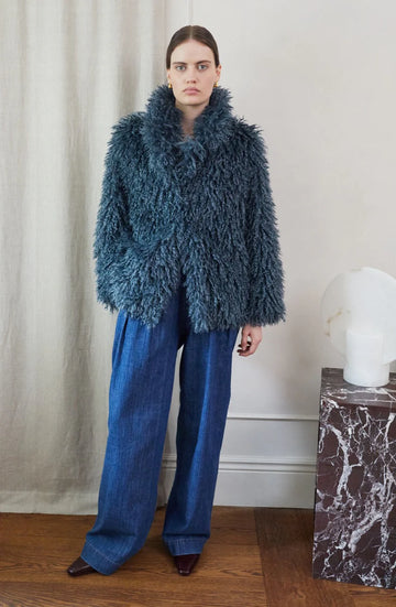 Blue faux fur short jacket worn with blue jeans