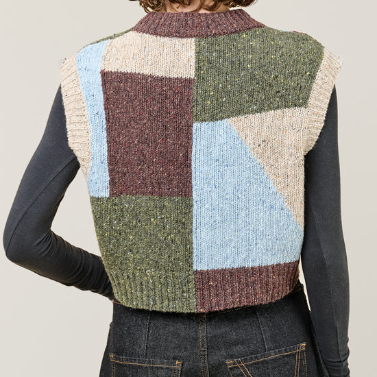 woman wearing multi colour geometric knit vest rear view
