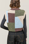 woman wearing multi colour geometric knit vest rear view