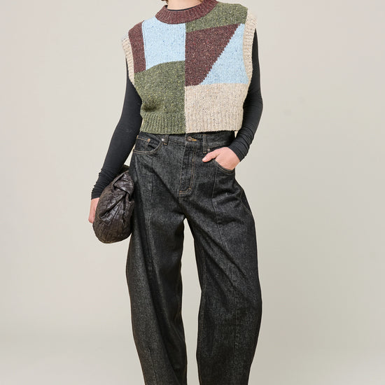 woman wearing multi colour geometric knit vest and jeans