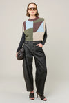 woman wearing multi colour geometric knit vest and jeans