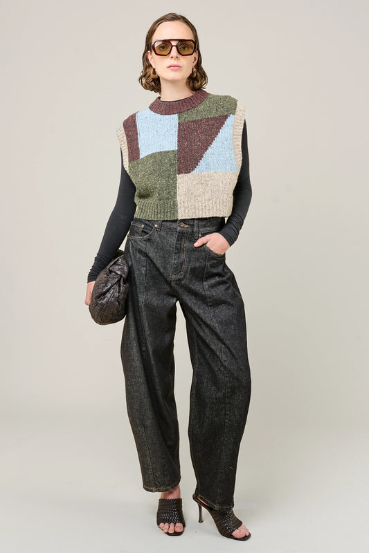 woman wearing multi colour geometric knit vest and jeans