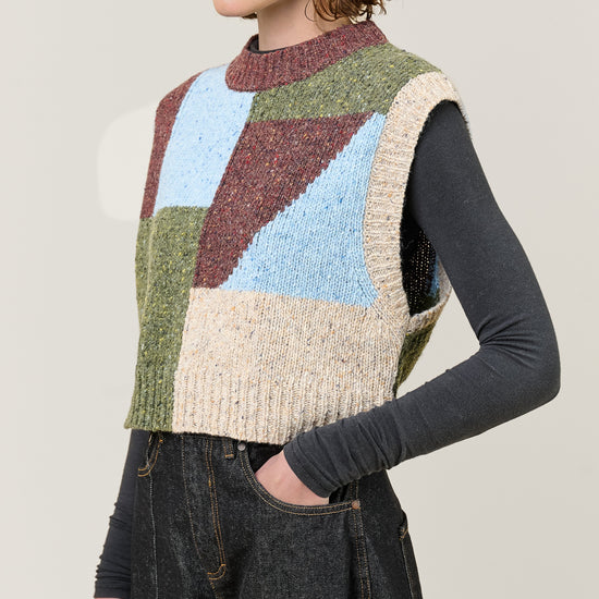 woman wearing multi colour geometric knit vest  side view