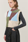 woman wearing multi colour geometric knit vest  side view