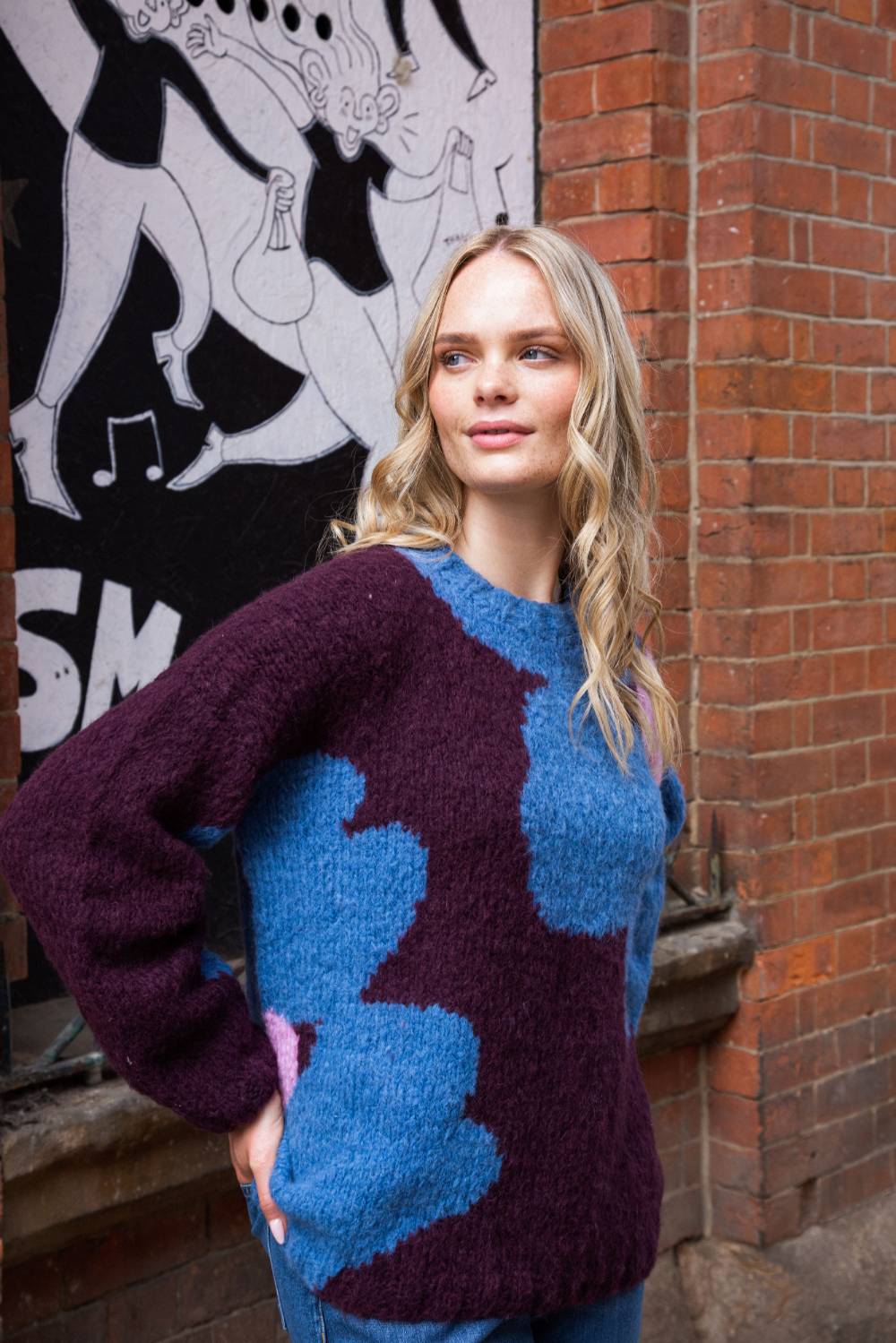 chunky round neck chocolate  jumper with mary quant style floral print in blue and pink side view 