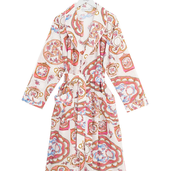 Patterned robe on a hanger against a white background
