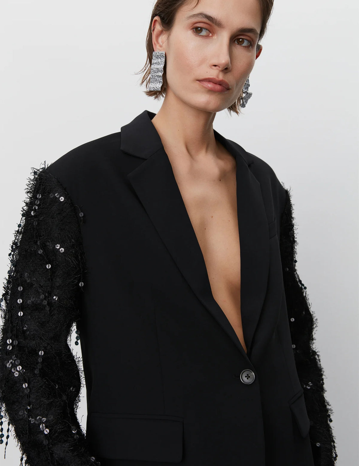 Black blazer with single breasted features and sequin and tassel sleeves black