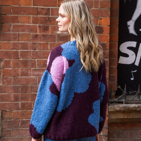 chunky round neck chocolate  jumper with mary quant style floral print in blue and pink  rear view 