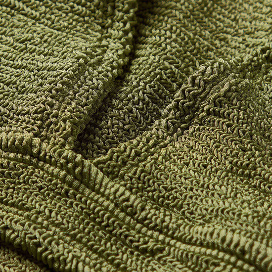 Close up of fabrication on green bikini
