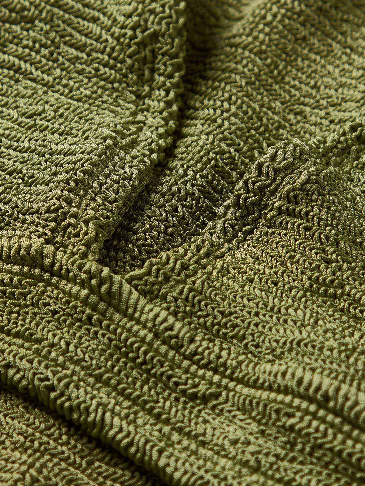 Close up of fabrication on green bikini