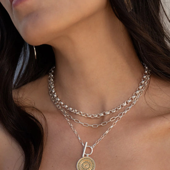 Model shot of mixed metal necklace with coin shaped pendant