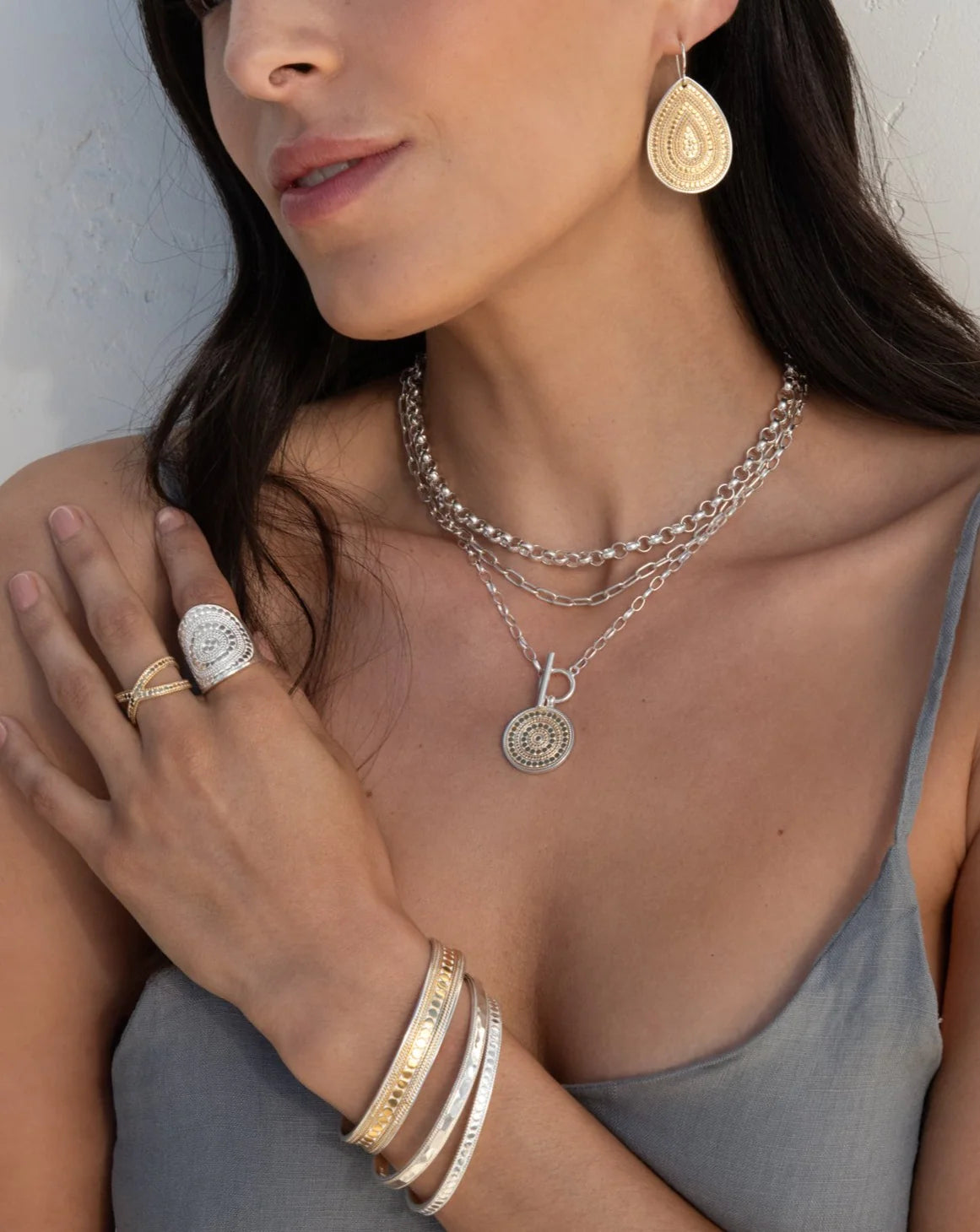 Mixed metal necklace with a coin shape pendant with balinese dot work