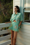 short sleeve light green oversized linen shirt with button flap pockets and crab on pockets from palm noosa model shot