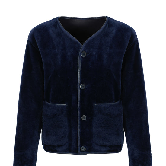 navy faux fur reversible round neck jacket with patch pockets, long sleeves, black buttons and interior dark navy faux suede with fur detailing