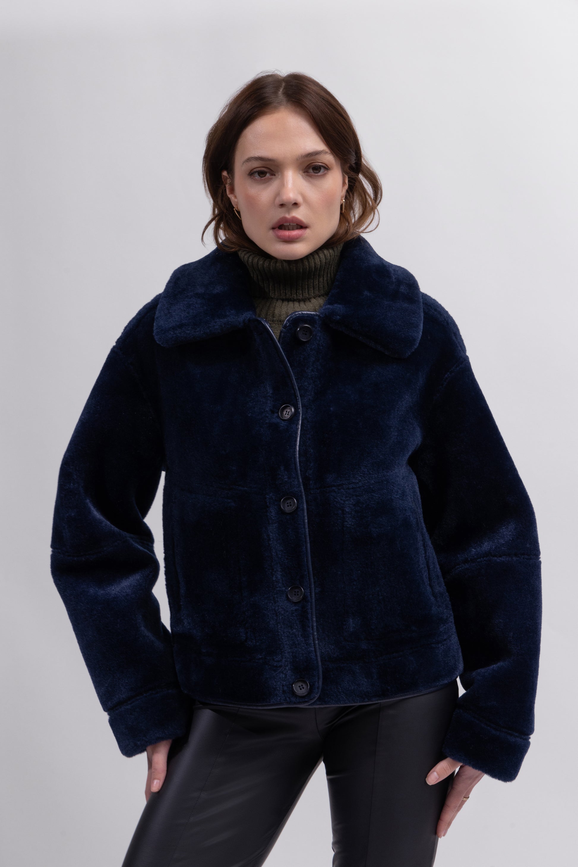 navy blue faux fur reversible short jacket with peter pan collar and side pockets model shot