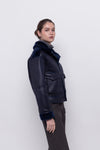 navy blue faux fur reversible short jacket with peter pan collar and side pockets side view