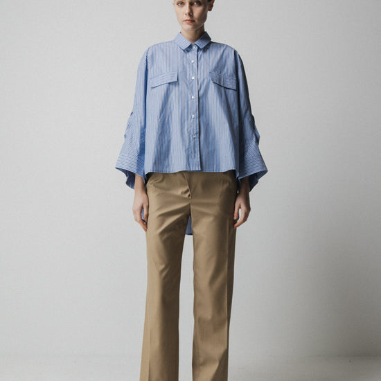 blue striped shirt with wide sleeves and dipped hem with chest pockets model shot