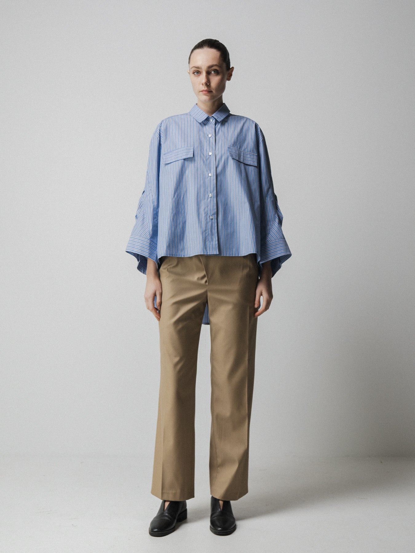 blue striped shirt with wide sleeves and dipped hem with chest pockets model shot