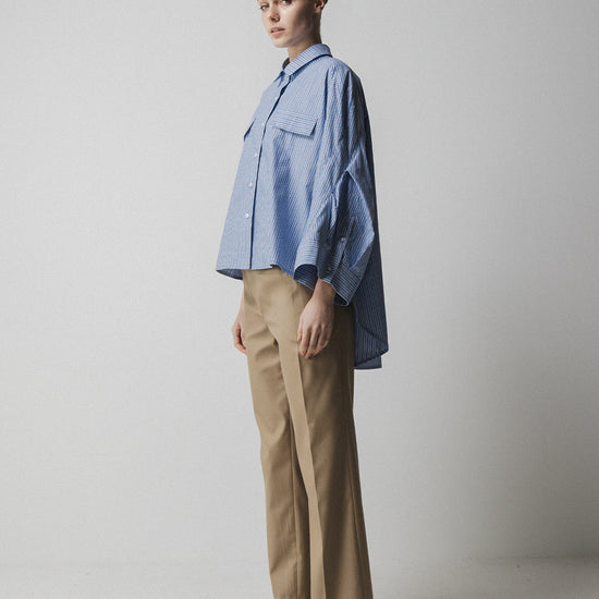 blue striped shirt with wide sleeves and dipped hem with chest pockets side view