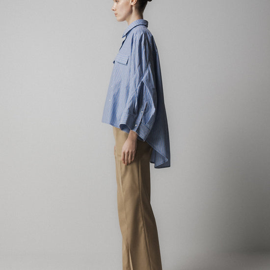 blue striped shirt with wide sleeves and dipped hem with chest pockets side view