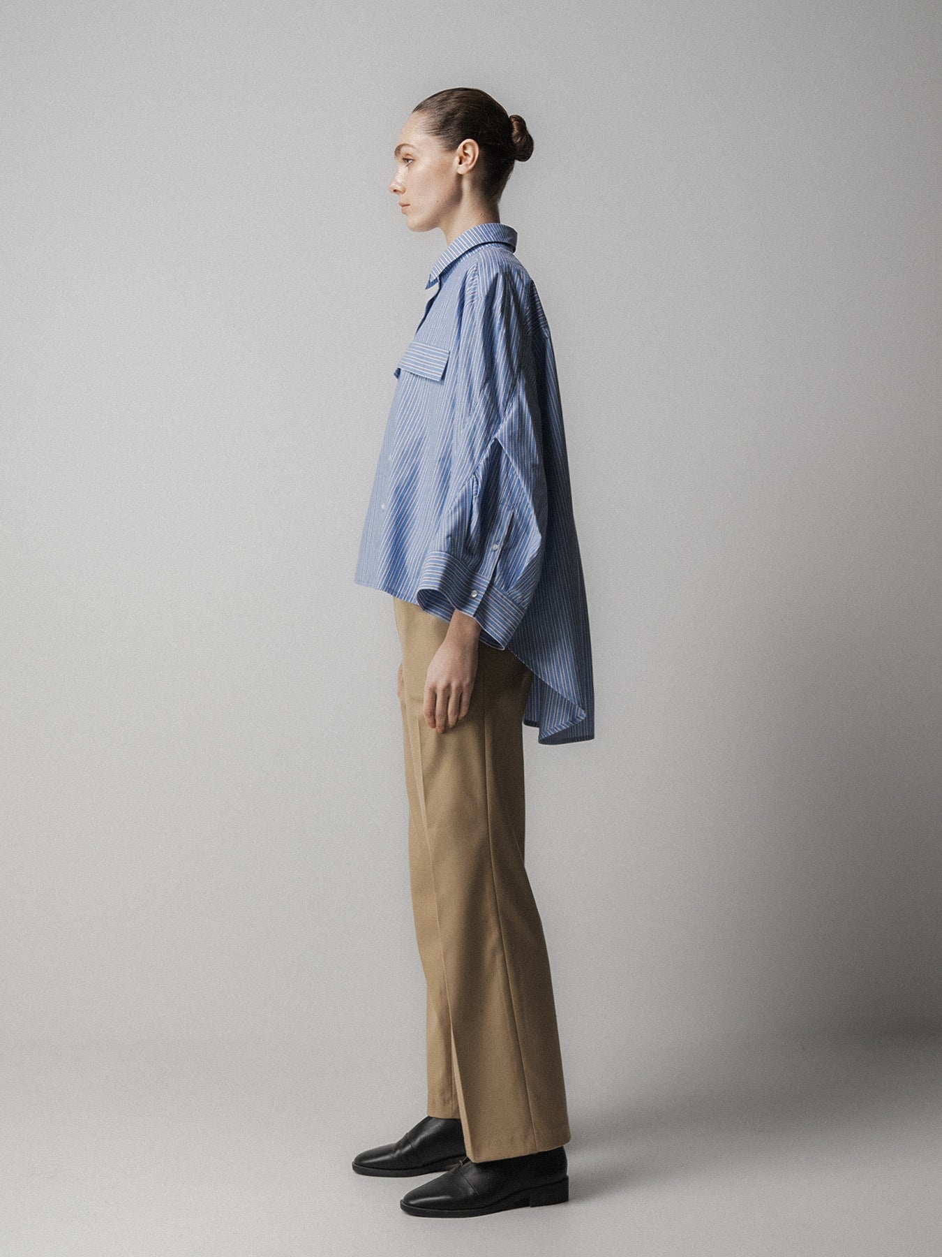 blue striped shirt with wide sleeves and dipped hem with chest pockets side view