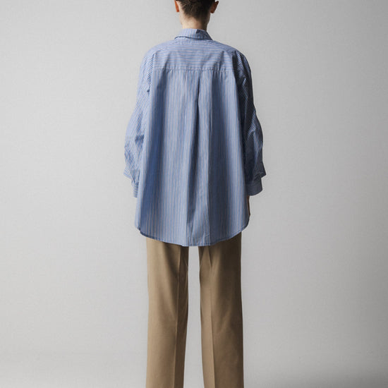 blue striped shirt with wide sleeves and dipped hem with chest pockets rear view