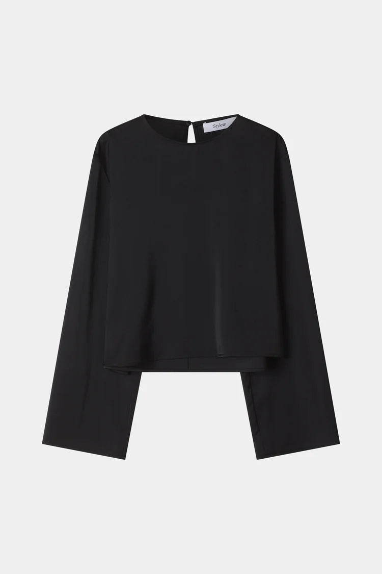 A black long-sleeve top with a unique layered, asymmetrical hem design, displayed flat against a light gray background.