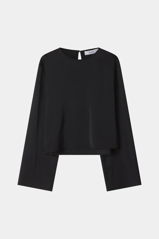 A black long-sleeve top with a unique layered, asymmetrical hem design, displayed flat against a light gray background.