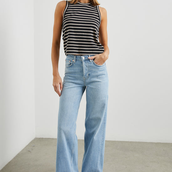 Sleeveless black and neutral stripe top with a round neck