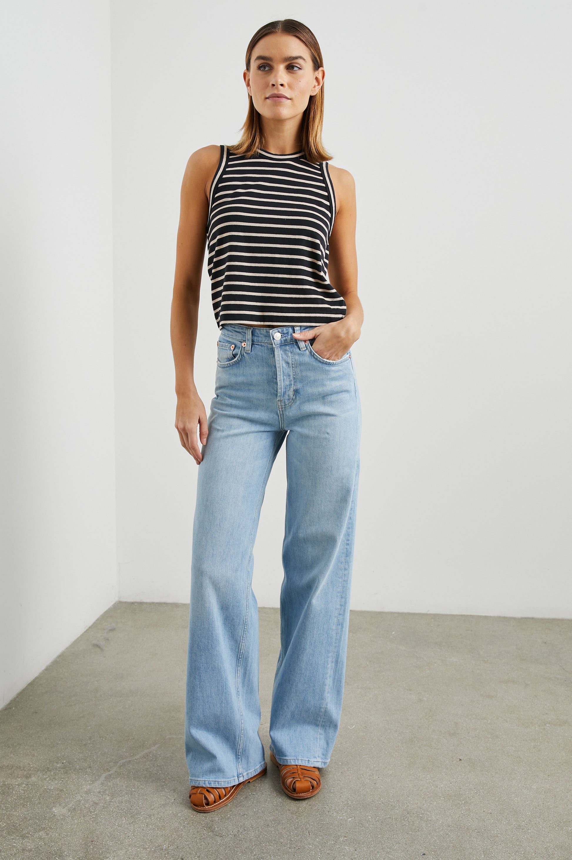 Sleeveless black and neutral stripe top with a round neck