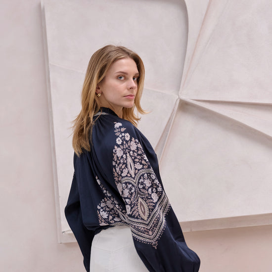 black silky blouse with paisley details and v neckline with a tie from brdr rear view