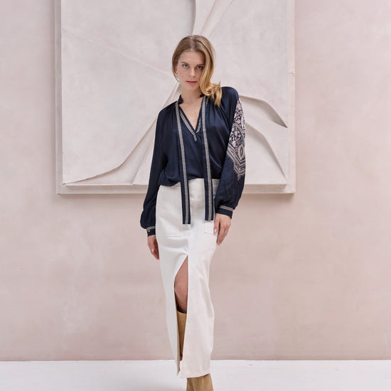 black silky blouse with paisley details and v neckline with a tie from brdr