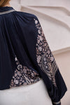 black silky blouse with paisley details and v neckline with a tie from brdr rear view