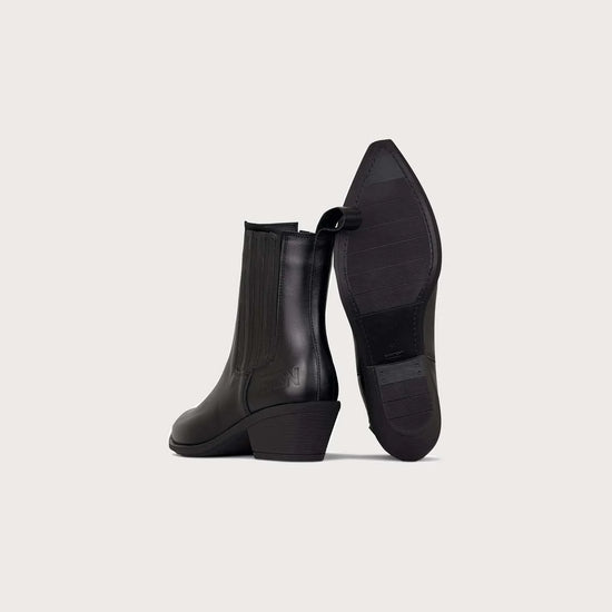 A pair of black leather ankle boots with low block heels, shown from the side and sole views against a light gray background.