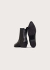 A pair of black leather ankle boots with low block heels, shown from the side and sole views against a light gray background.