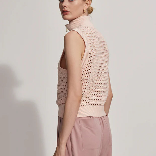 Sleeveless pointelle knit in pale pink with a half zip side view