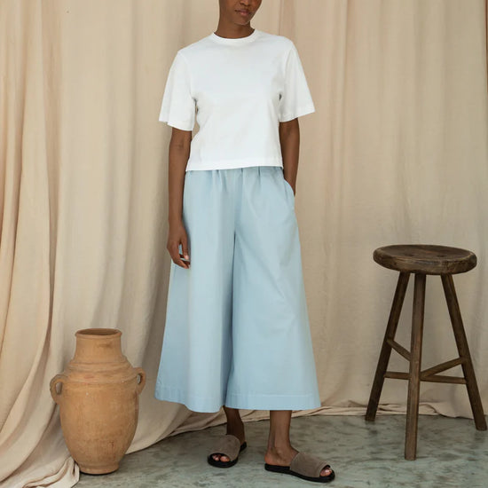 White tee worn with wide leg trousers