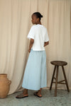 Rear view of white tee worn with wide leg trousers