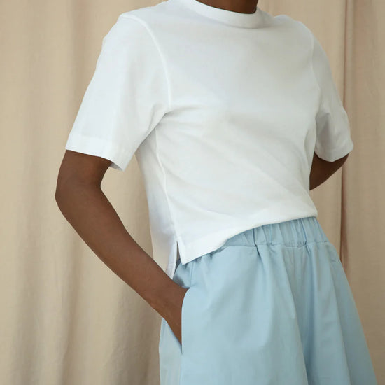 White tee worn with wide leg trousers