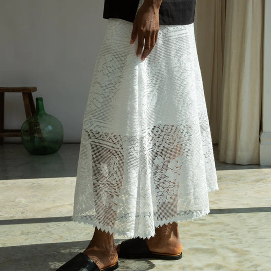 Person wearing a white lace skirt by Beaumont Organic close up