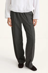 woman wearing grey trousers and white shirt rear view