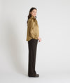 gold satin blouse with a tie bow at the neck and buttoned cuffs side view