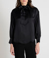 black satin blouse with a tie bow at the neck and buttoned cuffs
