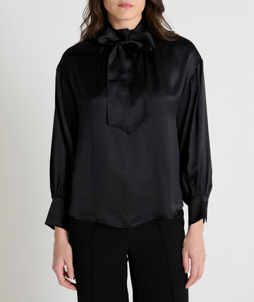 black satin blouse with a tie bow at the neck and buttoned cuffs