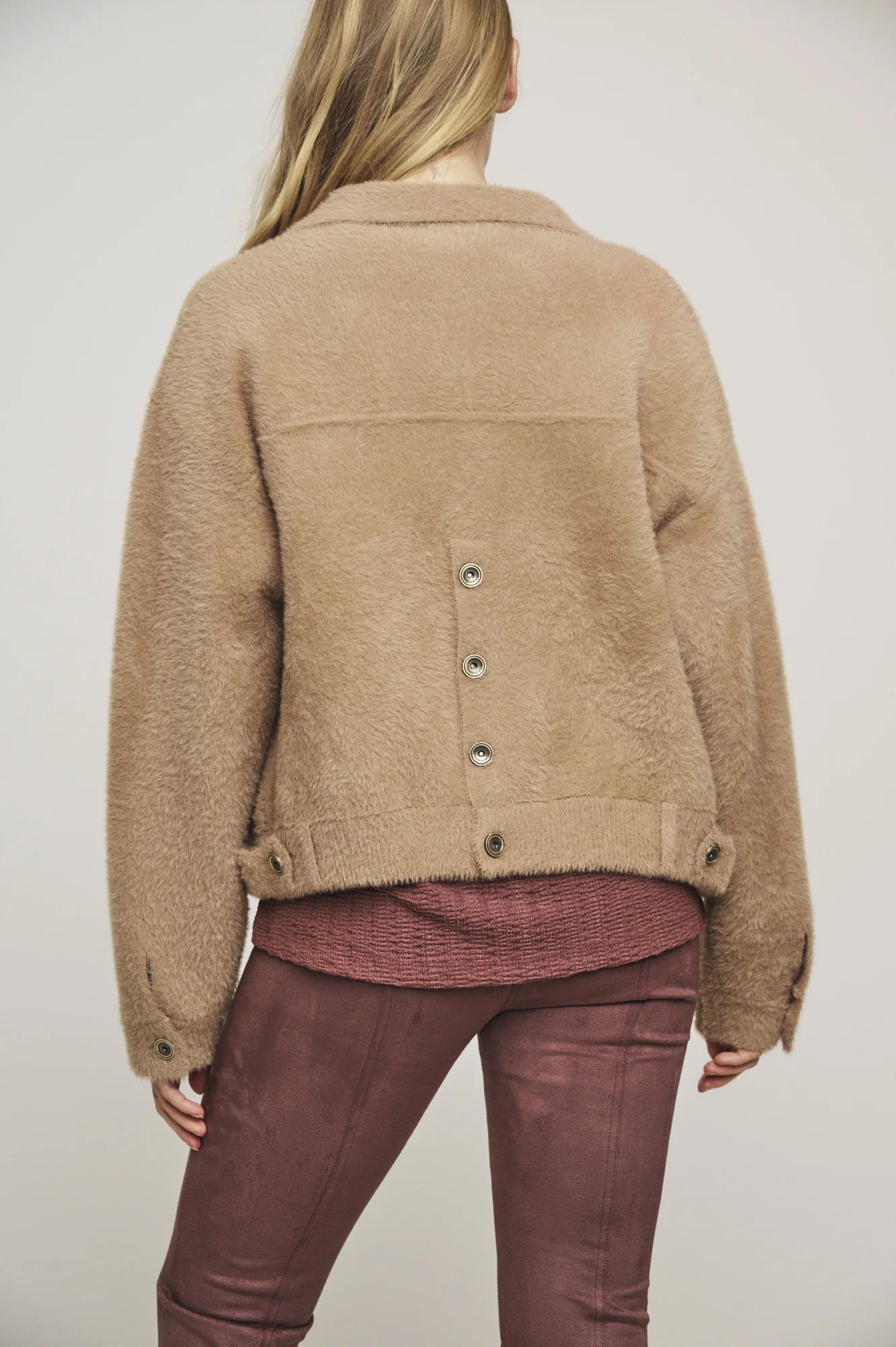 Rear view of button through jacket with button detail at the back